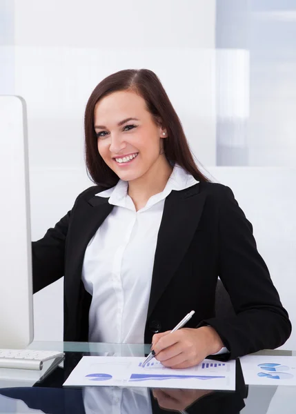 Businesswoman Using Computer In Office Stock Photo