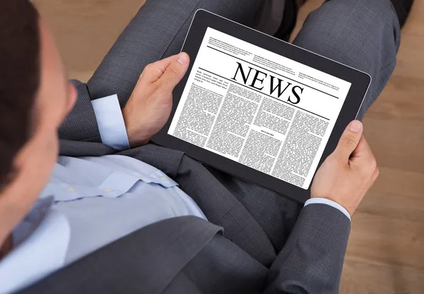 Businessman Reading News On Digital Tablet In Office — Stock Photo, Image