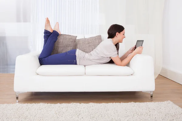 Woman Using Digital Tablet On Sofa — Stock Photo, Image