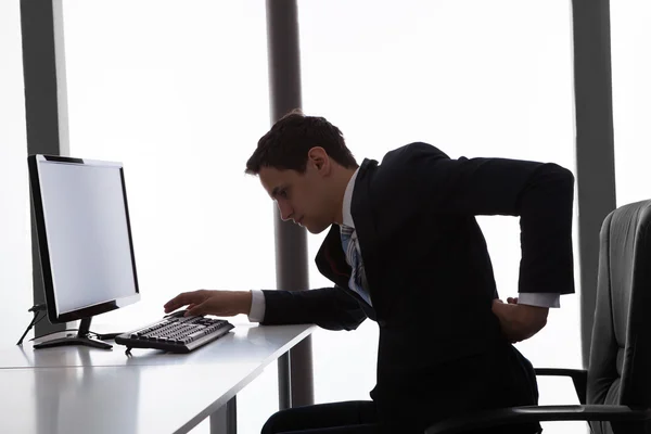 Businessman Suffering From Backache In Office — Stock Photo, Image