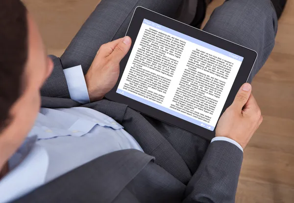 Businessman Reading eBook In Office — Stock Photo, Image