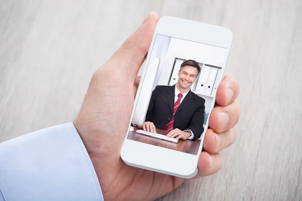 Zakenman videoconfereren met collega bij receptie — Stockfoto