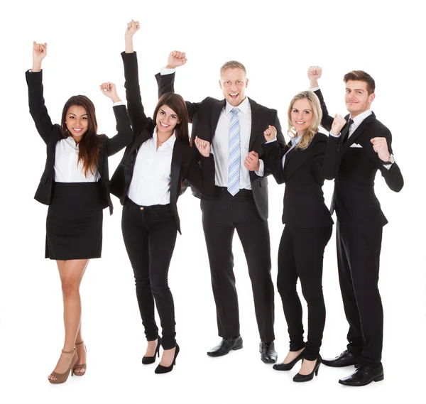 Successful Welldressed Businesspeople With Arms Raised Stock Photo