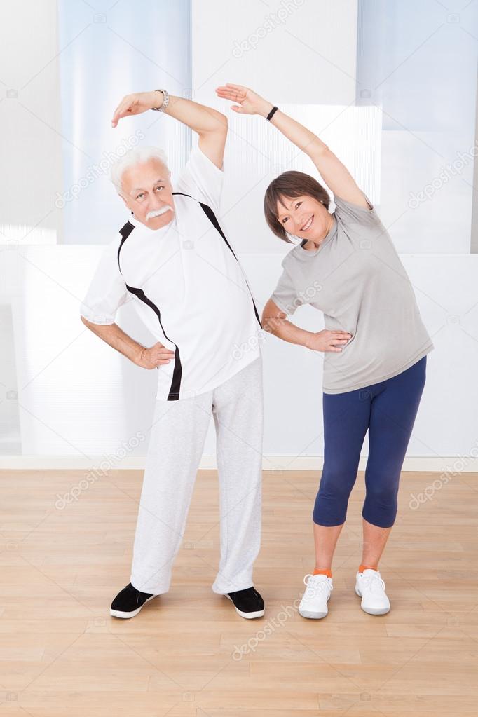 Senior Couple Doing Stretching Exercise