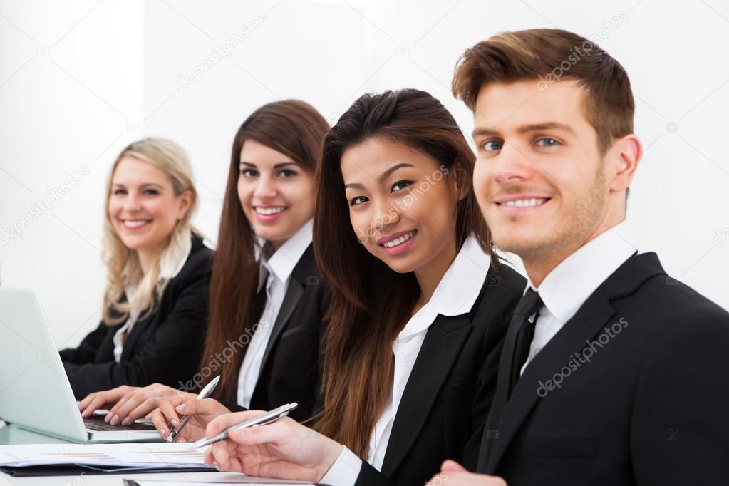 Confident Businesswoman With Colleagues