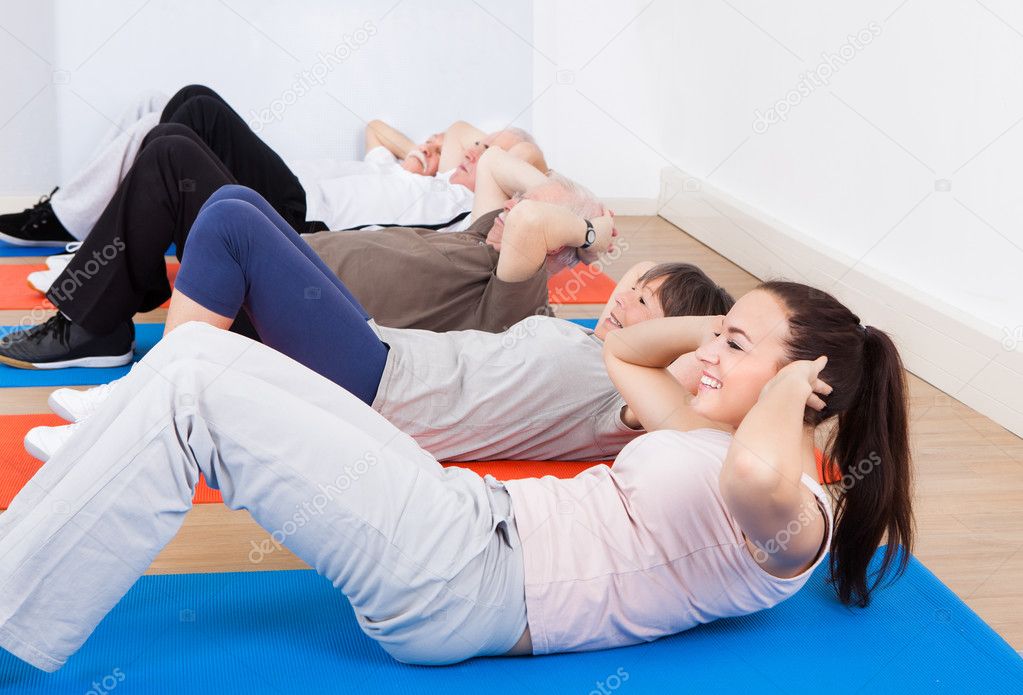 People Doing Sit Ups At Gym