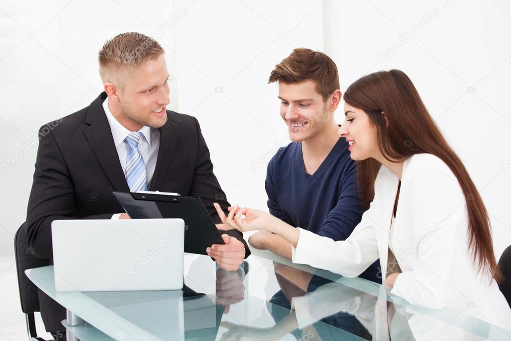 Couple Discussing With Financial Advisor