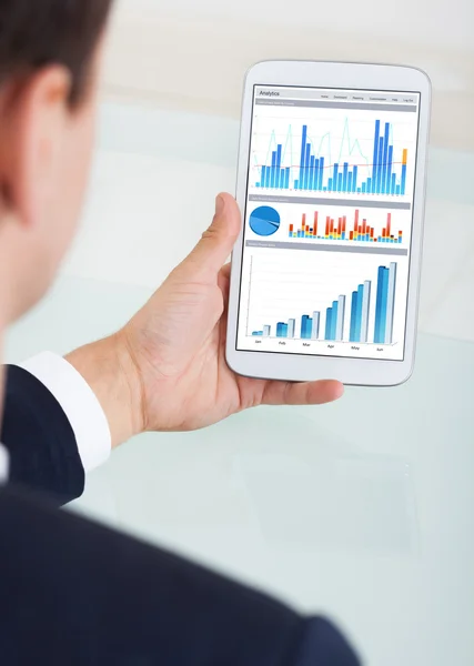 Businessman Comparing Graphs On Digital Tablet — Stock Photo, Image