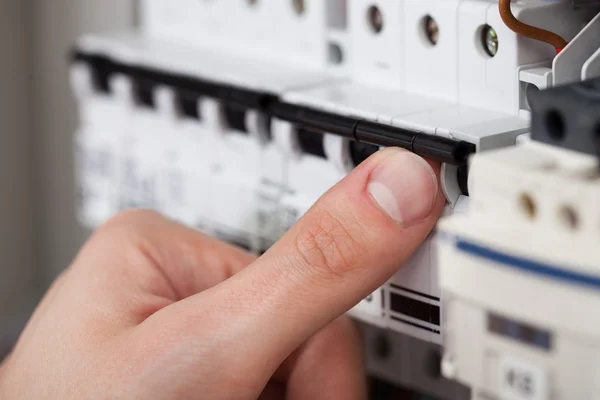 Technician Turning On Switch In Fusebox — Stock Photo, Image