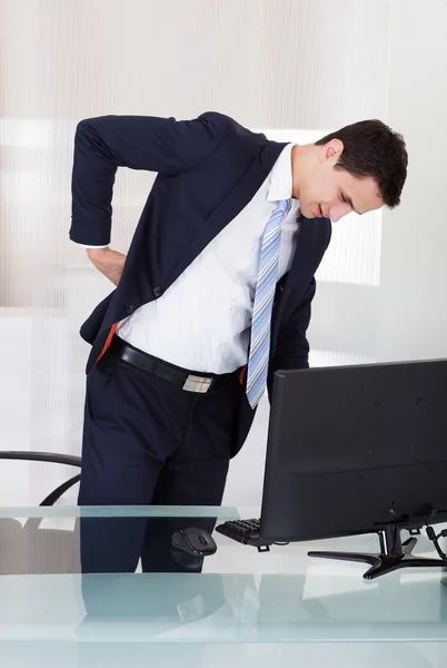 Hombre de negocios que sufre de dolor de espalda — Foto de Stock