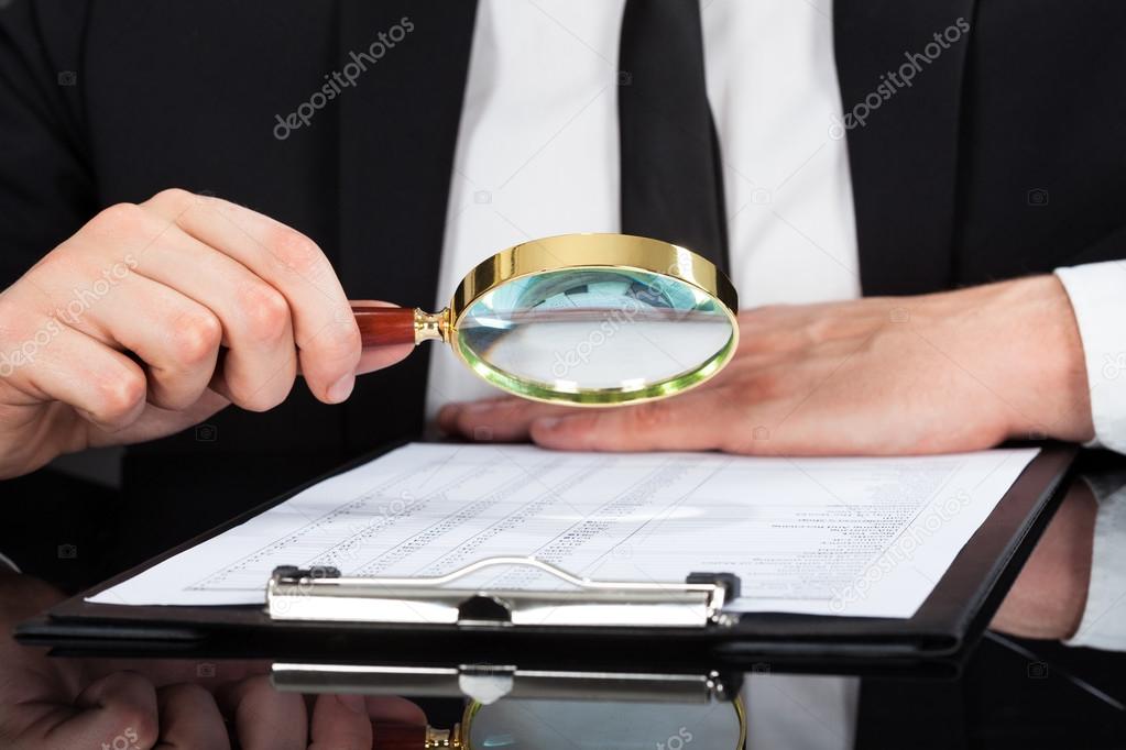 Businessman With Magnifying Glass