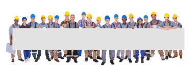 Multiethnic Manual Workers Holding Blank Banner clipart