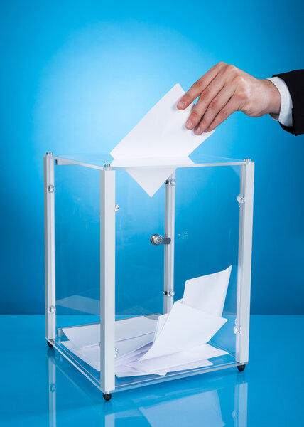 Businessman Putting Paper In Polling Box