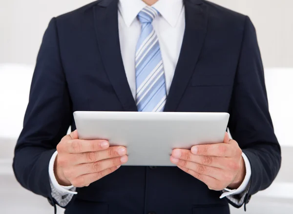 Podnikatel drží digitálním tabletu v úřadu — Stock fotografie