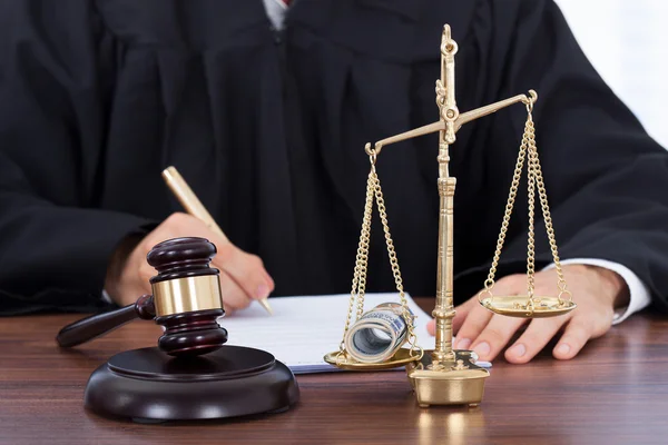 Male Judge Signing Document In Courtroom — Stock Photo, Image