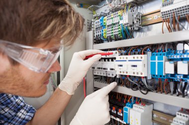 Electrical Engineer Examining Fusebox clipart