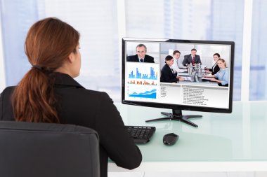 Businesswoman Video Conferencing With Team On Computer clipart