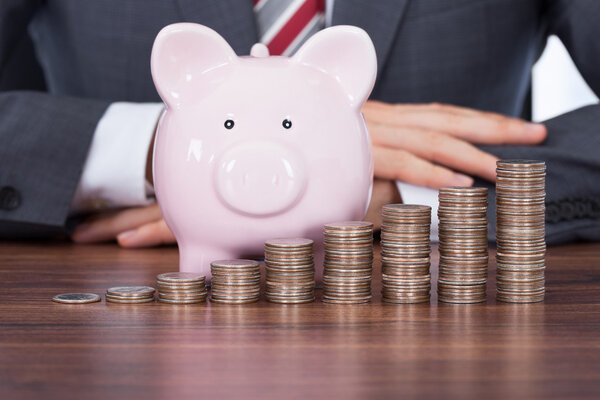 Businessman With Piggybank