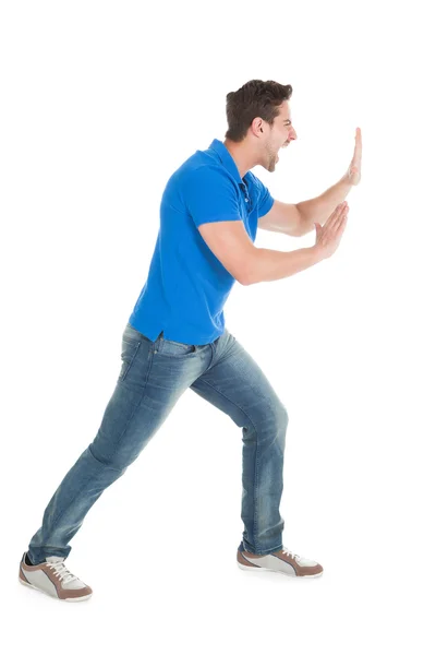 Confident Man Pushing Billboard — Stock Photo, Image