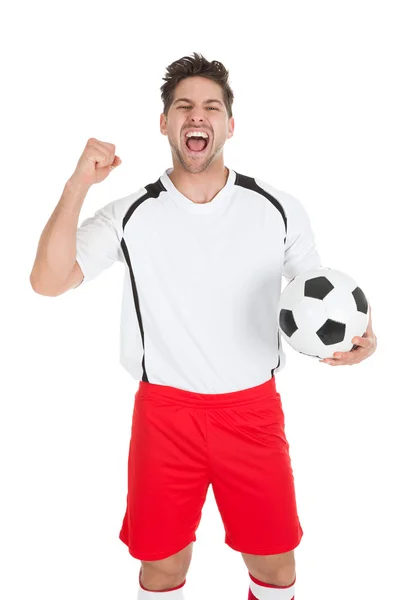 Fotbalista drží míč — Stock fotografie