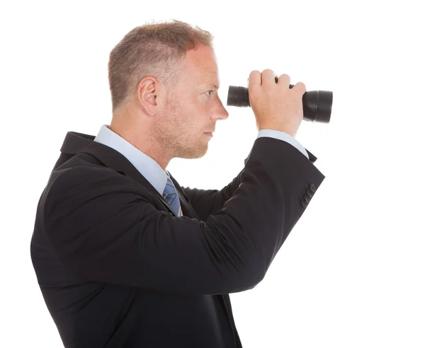 Geschäftsmann blickt durch Fernglas — Stockfoto