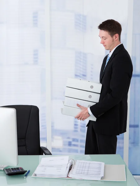 Businessman Carrying Stacked Binders — Stock Photo, Image