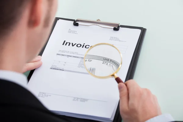 Businessman Examining Invoice — Stock Photo, Image