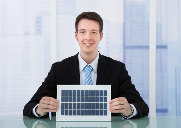 T бізнесмен холдингу панелі сонячних батарей — стокове фото