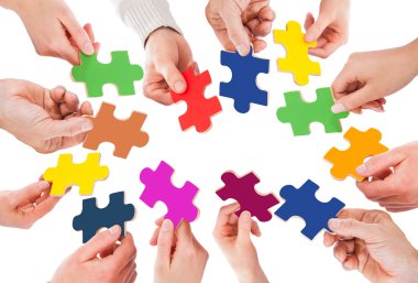 Business People Holding Jigsaw Pieces clipart