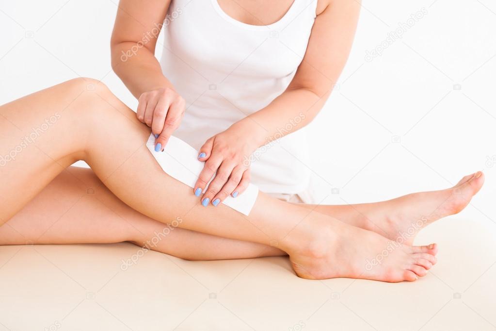 Female Therapist Waxing Customer's Leg