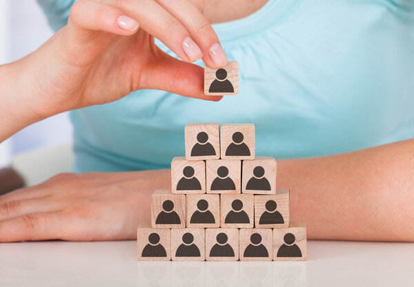 Woman Stacking Wooden Team Blocks