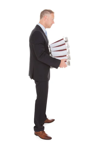 Businessman Carrying Stack Of Binders — Stock Photo, Image