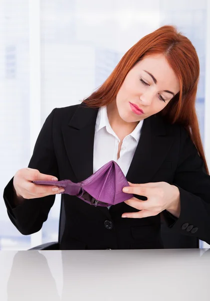 Geschäftsfrau blickt auf leere Brieftasche — Stockfoto