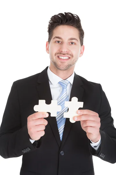 Businessman Holding Puzzle Pieces — Stock Photo, Image