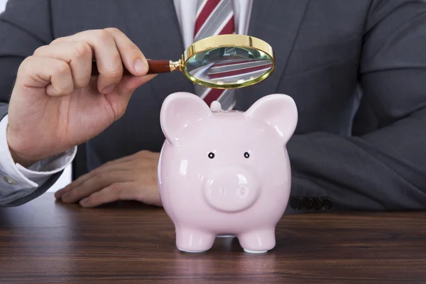 Empresário Examinando Piggybank — Fotografia de Stock