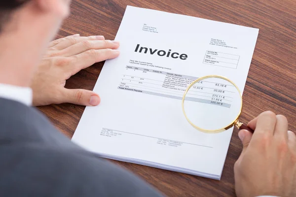 Businessman Examining Invoice — Stock Photo, Image