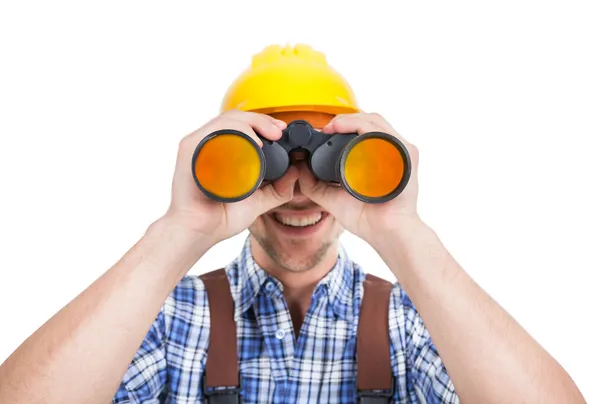 Reparatör tittar genom kikare — Stockfoto