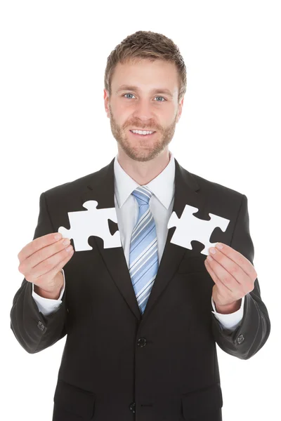 Businessman Holding Puzzle — Stock Photo, Image