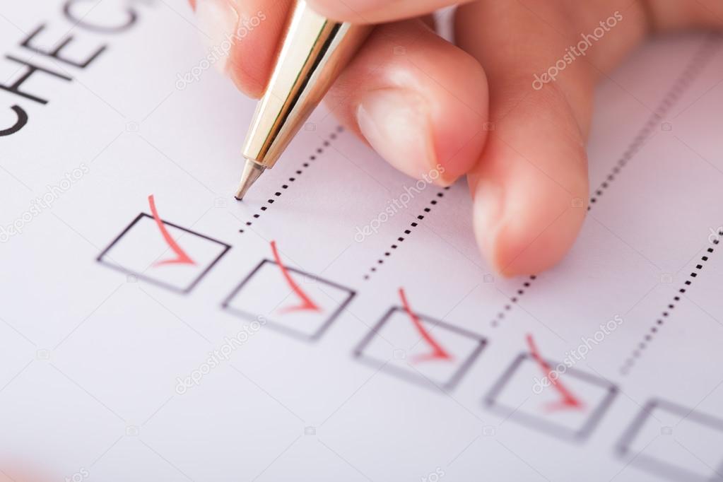 Businesswoman Writing On Checklist