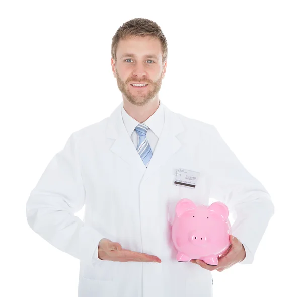 Doctor Holding Piggybank — Stock Photo, Image