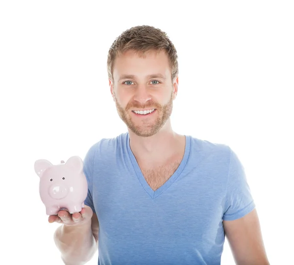 Homem segurando Piggybank — Fotografia de Stock