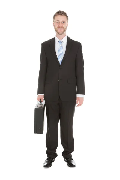 Jonge zakenman met koffer — Stockfoto