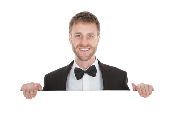 Butler holding blank billboard — Stock Photo, Image