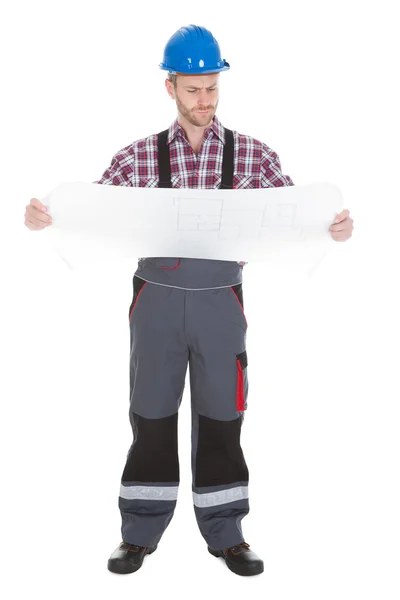 Male worker reading blueprint — Stock Photo, Image