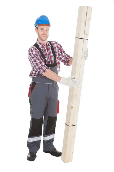 Male carpenter holding wooden planks — Stock Photo, Image