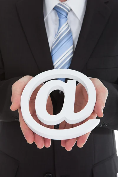 Businessman holding internet symbol — Stock Photo, Image