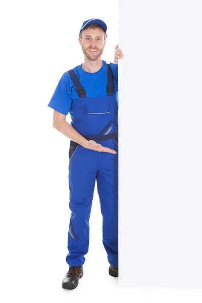 Smiling manual worker with billboard — Stock Photo, Image