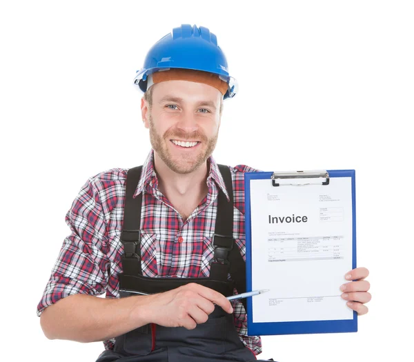 Smiling handyman showing invoice — Stock Photo, Image