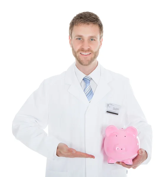 Mid volwassen arts bedrijf spaarpot — Stockfoto