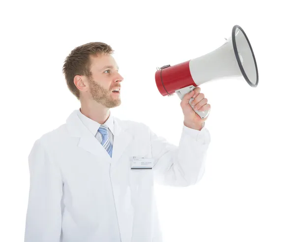 Doctor screaming into megaphone — Stock Photo, Image